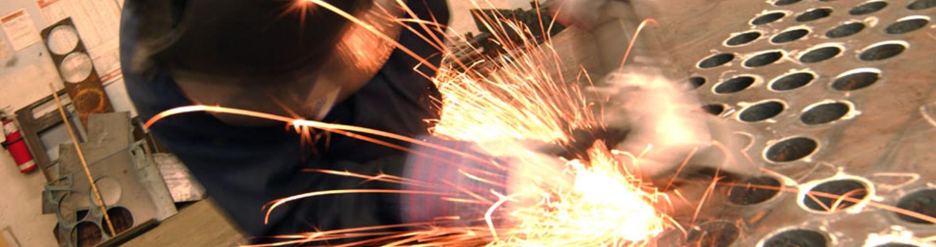 person welding metal with sparks