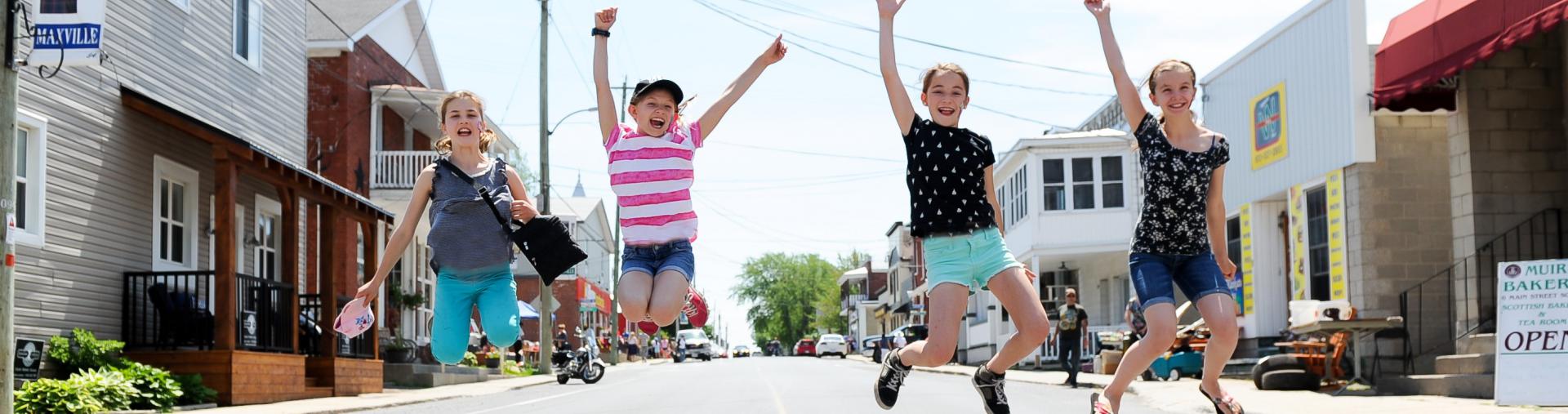 Students jumping on Main Street.