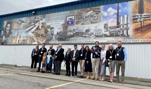 Members of the Ault family stand under the mural following the unveiling ceremony on Friday.