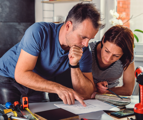 A couple examines renovation plans.