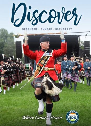 The cover of the 2022 SDG Discover Guide features the massed bands at the Glengarry Highland Games.