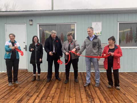 Officials cut the ribbon on a new building at Summerstown Forest.