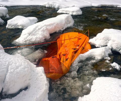 a damaged tent in the water