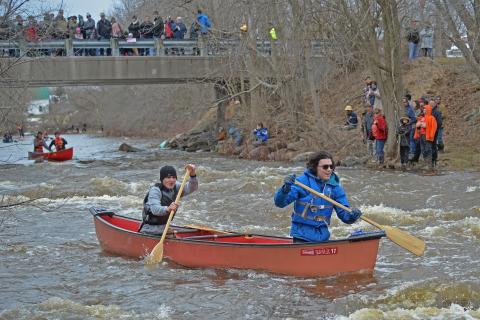 Paddlers fight through the Devil's Chute rapids during a past Raisin River Canoe Race.