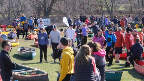 Paddlers and boats gather at the start line during last year's Raisin River Canoe Race.
