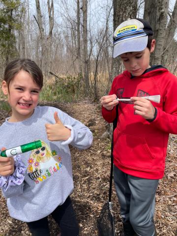 Two young geocachers find their first cache.