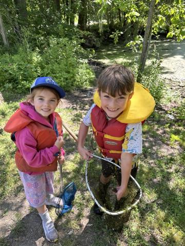 Eco Friends from this year's camp at Cooper Marsh learn how to properly catch, hold, and identify frogs.