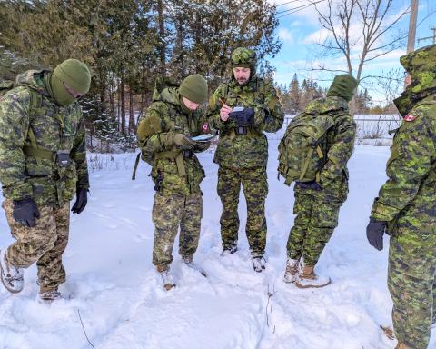 soldiers work in the snow